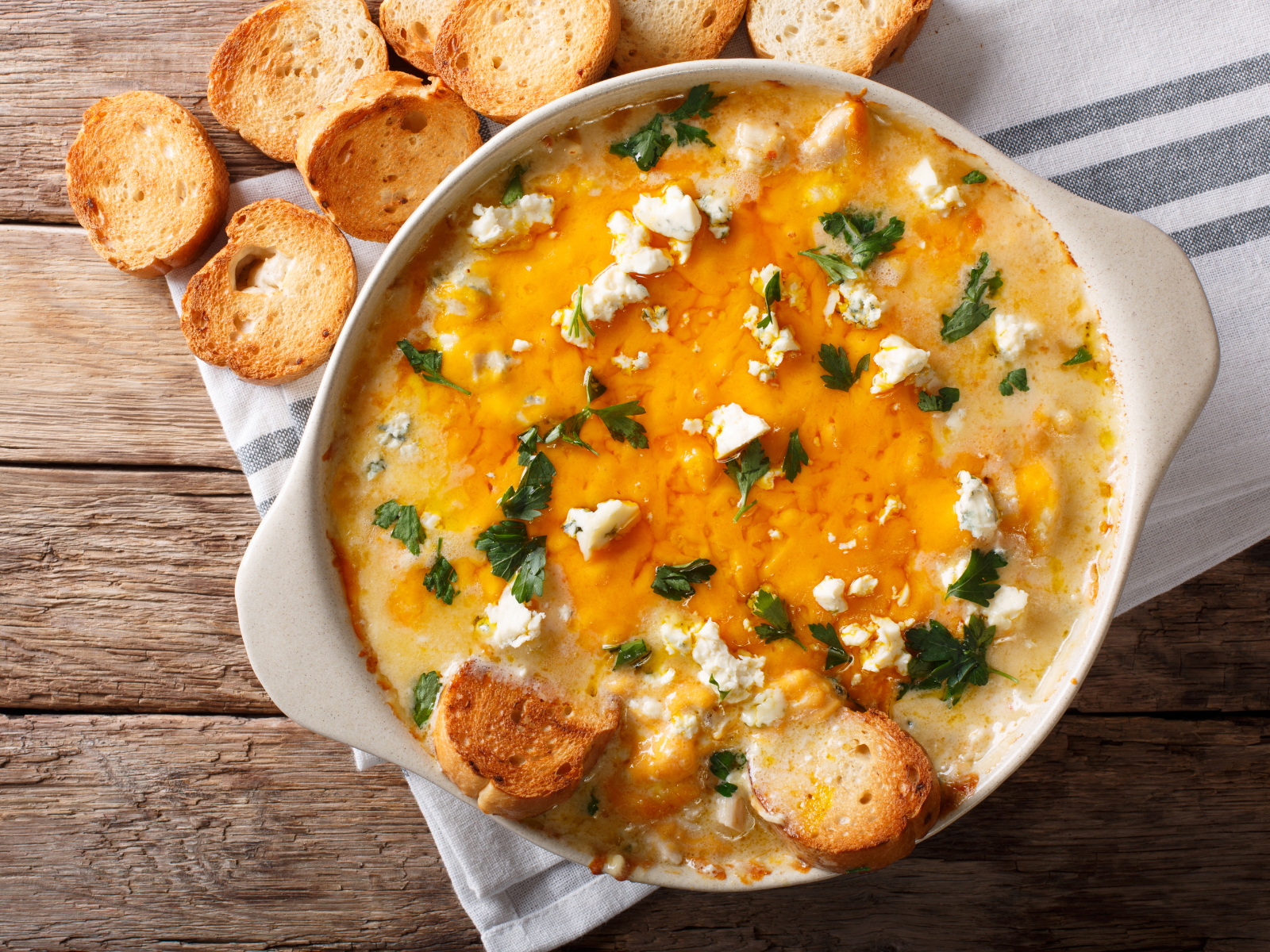 buffalo chicken dip in a pan with bagel chips
