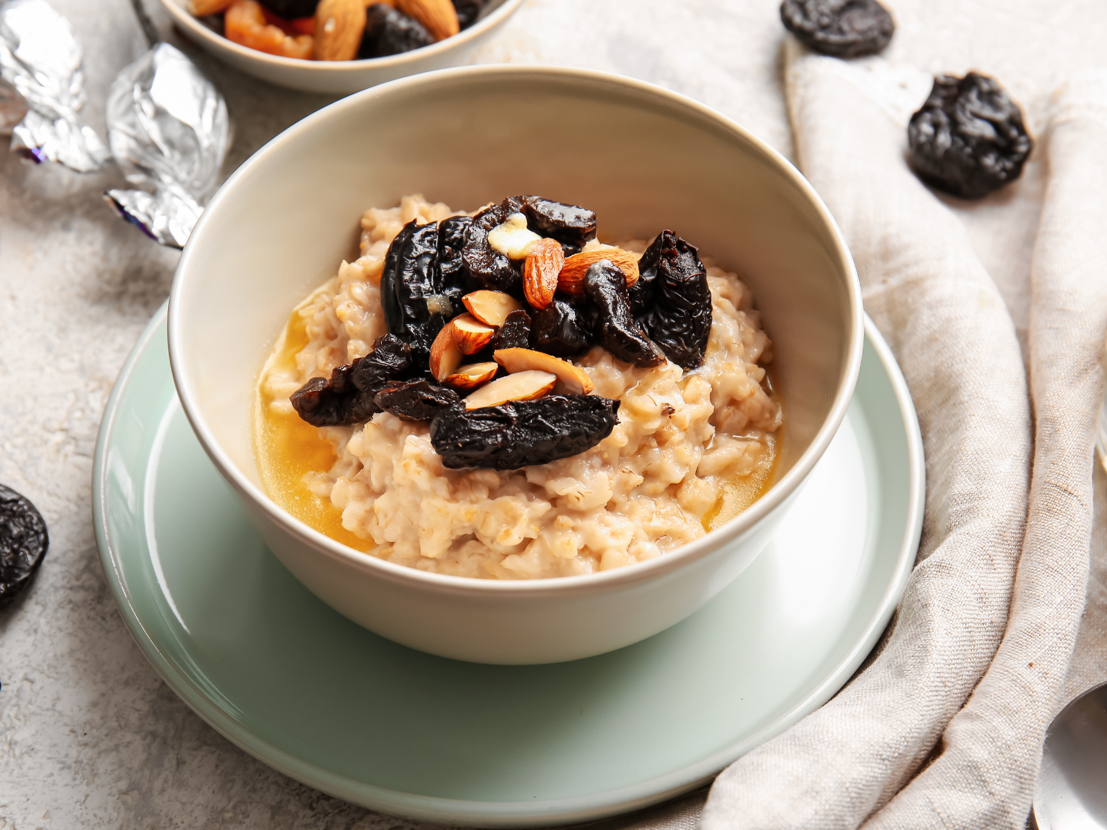 bowl of oatmeal with prunes and nuts